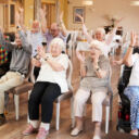 Group Of Seniors Enjoying Fitness Class In Retirement Home